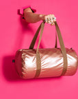 Loqi Weekender Tasche in Rose Gold vor pinkem Hintergrund